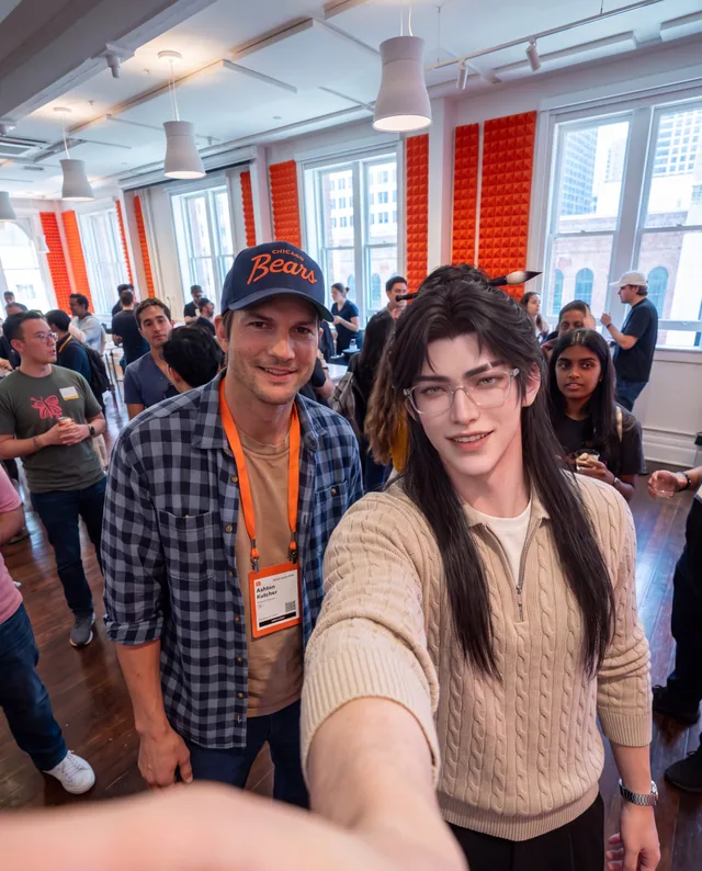 Instinct taking a selfie with a guest at a crowded event.